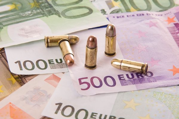Euro bank notes and bullets